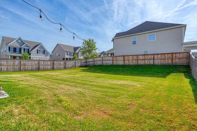 view of yard with a residential view and a fenced backyard