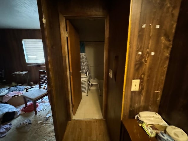 hallway with wood walls