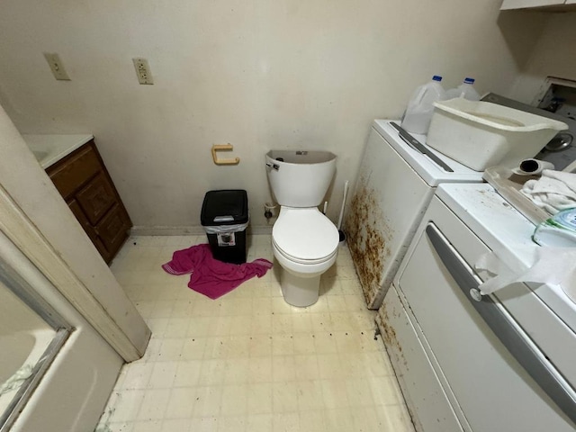full bath featuring toilet, tile patterned floors, washing machine and dryer, and vanity