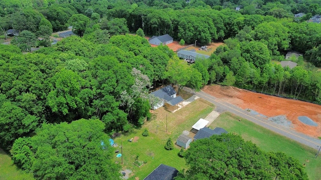 birds eye view of property featuring a view of trees