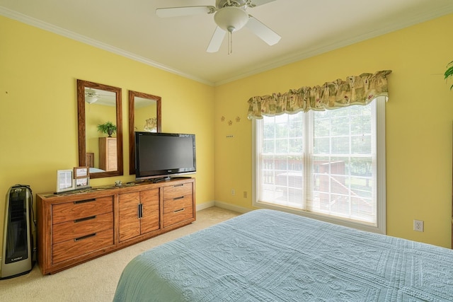bedroom with ornamental molding, a ceiling fan, and light colored carpet