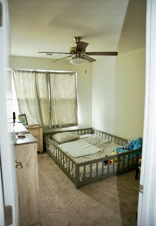 carpeted bedroom featuring ceiling fan