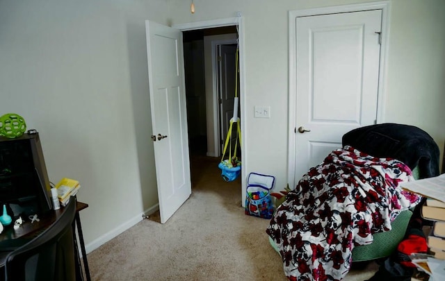 carpeted bedroom featuring baseboards