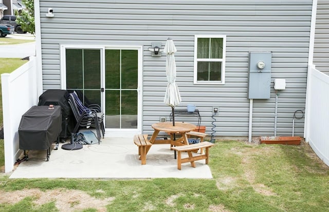 rear view of house with a yard and a patio area