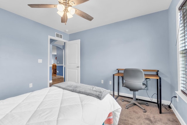 bedroom with visible vents, a ceiling fan, baseboards, arched walkways, and carpet flooring