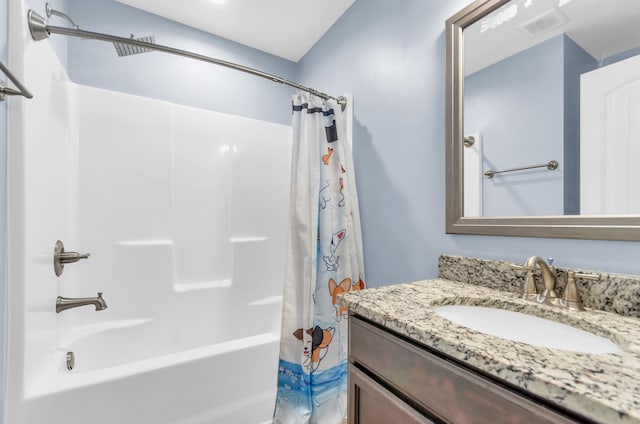 bathroom featuring visible vents, shower / bath combination with curtain, and vanity
