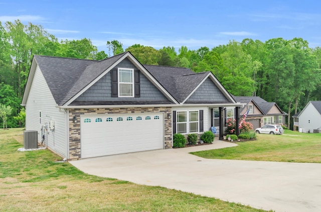 craftsman inspired home with a garage, stone siding, concrete driveway, and a front yard