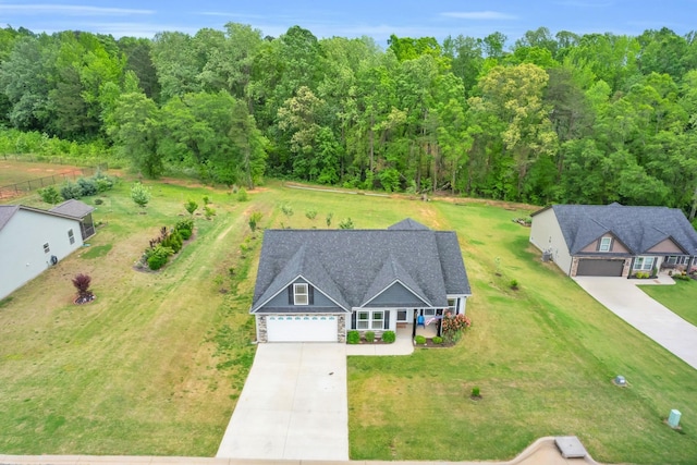 bird's eye view with a wooded view