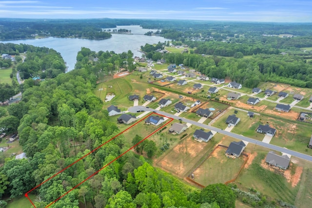 bird's eye view with a water view, a residential view, and a wooded view