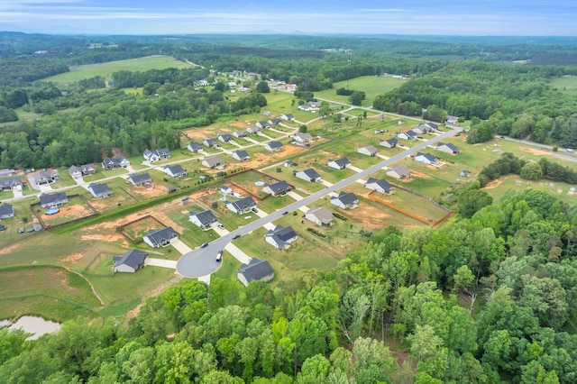 birds eye view of property with a residential view and a forest view