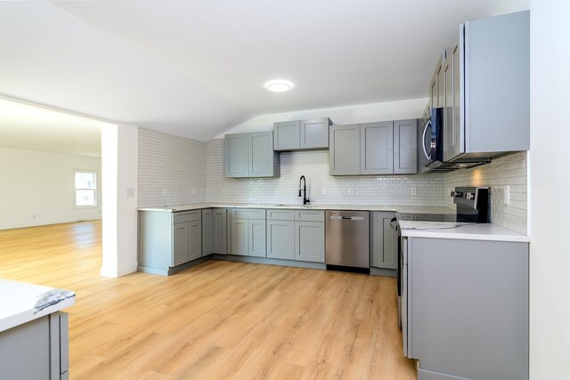 583 Berry, Boiling Springs, SC 29316 - kitchen featuring appliances with stainless steel finishes, tasteful backsplash, gray cabinetry, light countertops, and light wood finished floors