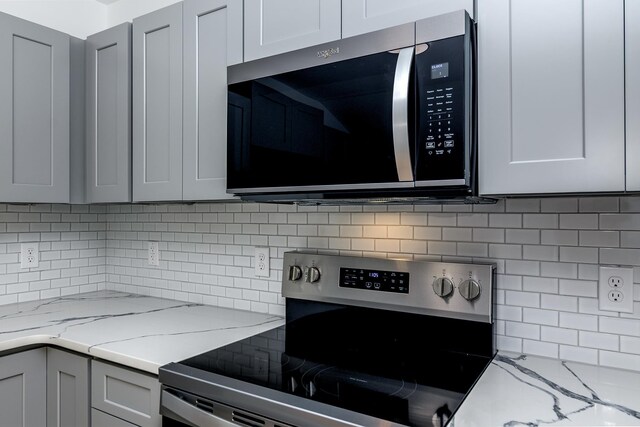 583 Berry, Boiling Springs, SC 29316 - kitchen featuring gray cabinets, decorative backsplash, light stone countertops, and stainless steel appliances
