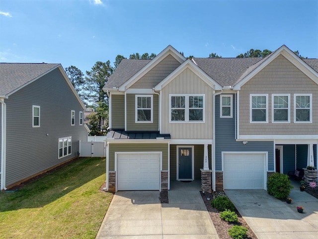 multi unit property with board and batten siding, driveway, stone siding, and a front lawn