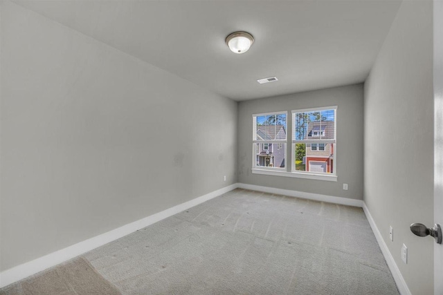 spare room featuring baseboards, carpet flooring, and visible vents