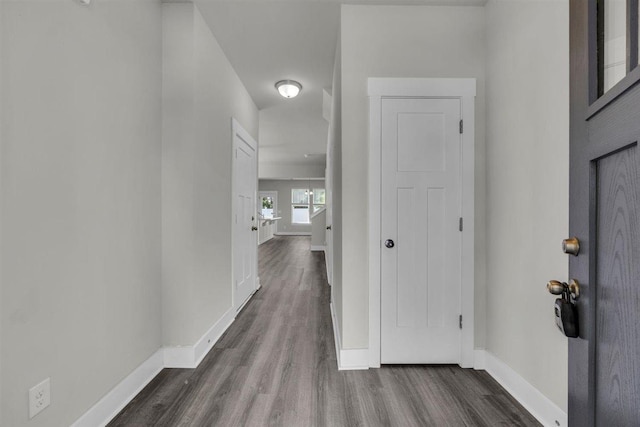 hallway with baseboards and dark wood finished floors