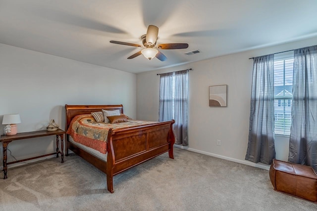 carpeted bedroom with a ceiling fan, baseboards, and visible vents