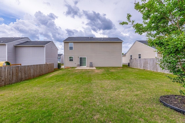 back of house featuring a lawn, a patio, and fence