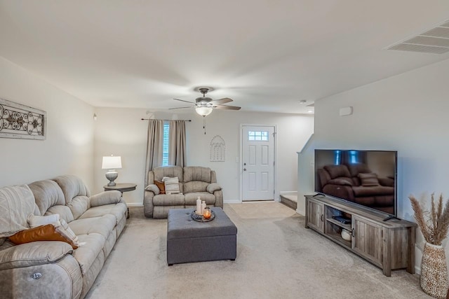 living room with baseboards, ceiling fan, light colored carpet, and visible vents