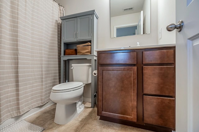 bathroom featuring visible vents, tile patterned floors, toilet, and vanity