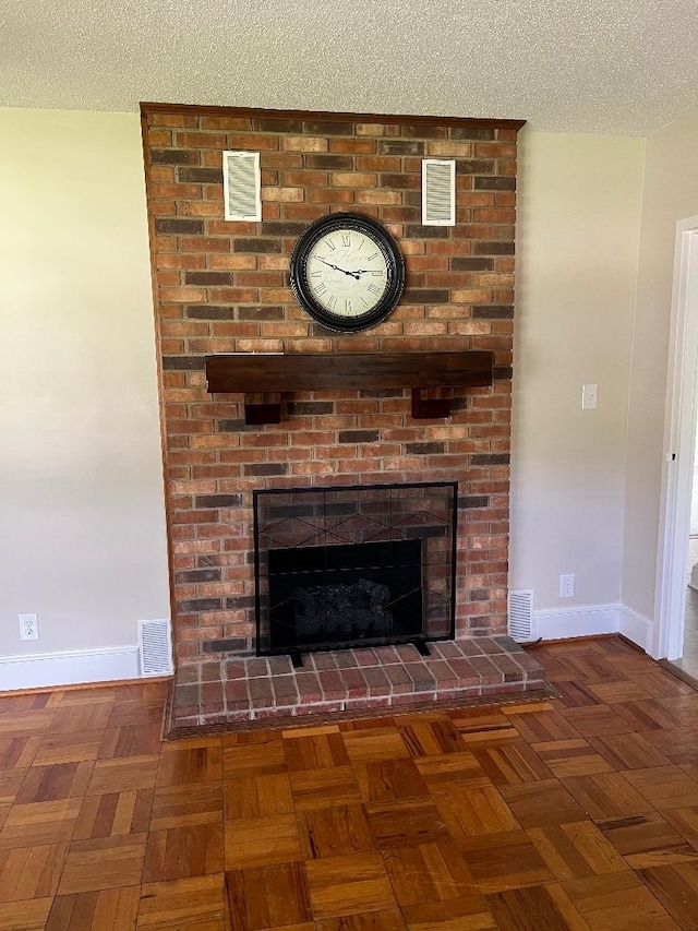 room details featuring baseboards, a textured ceiling, and visible vents