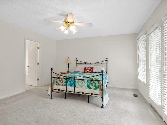 bedroom featuring carpet flooring, baseboards, and a ceiling fan