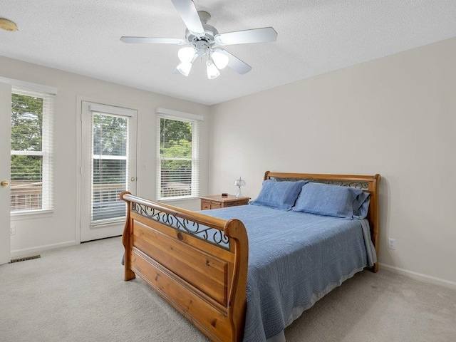 bedroom featuring light colored carpet, baseboards, and access to exterior