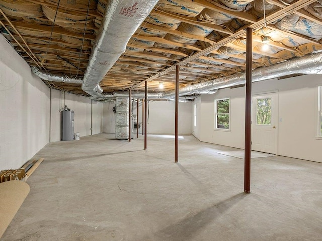 below grade area featuring water heater and heating unit