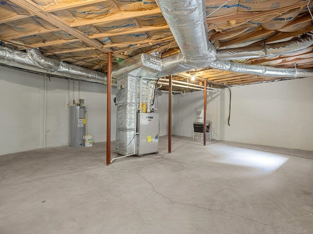 unfinished below grade area with electric water heater and heating unit