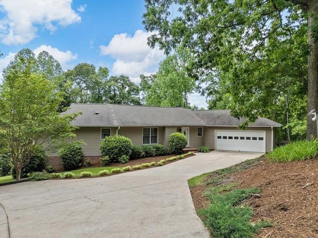 ranch-style home with concrete driveway and an attached garage