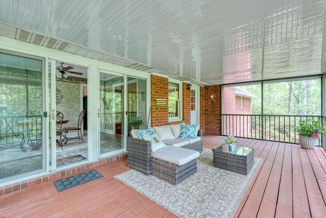 sunroom / solarium with ceiling fan and outdoor lounge area