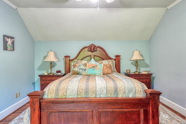 bedroom with lofted ceiling, baseboards, ceiling fan, and wood finished floors