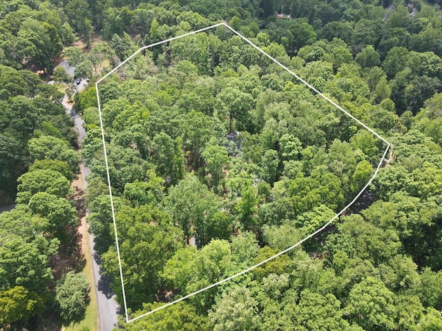 birds eye view of property featuring a wooded view