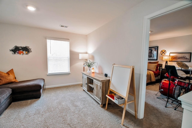 carpeted home office featuring baseboards and visible vents