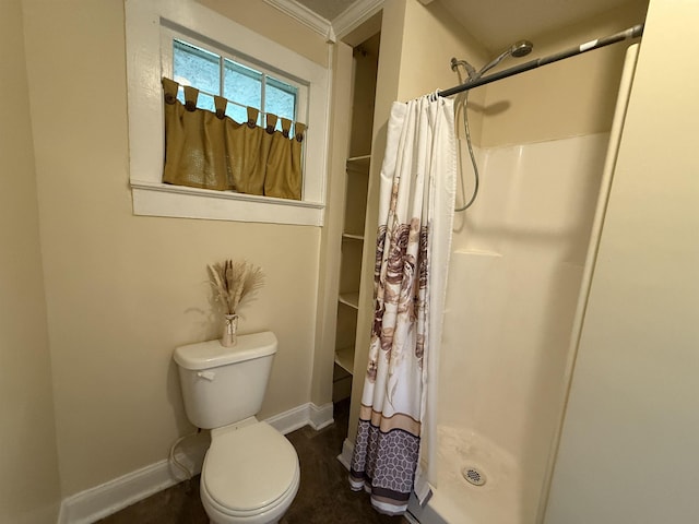 bathroom with curtained shower, baseboards, and toilet