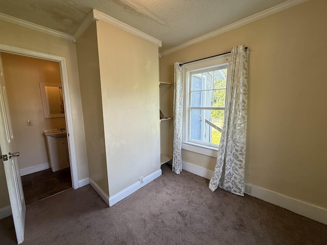 unfurnished bedroom featuring baseboards, a textured ceiling, ornamental molding, and carpet floors