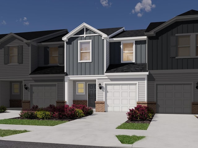 view of front of house with driveway, an attached garage, brick siding, and board and batten siding