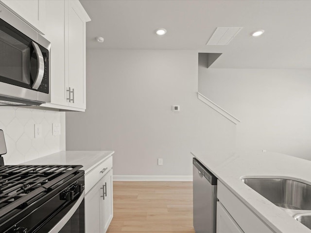 124 Arrow, Greer, SC 29651 - kitchen with stainless steel appliances, white cabinets, light stone countertops, light wood-style flooring, and recessed lighting