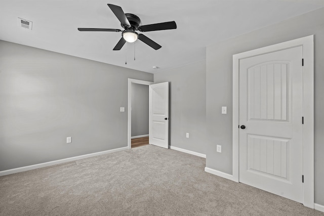 unfurnished bedroom featuring baseboards, carpet flooring, visible vents, and a ceiling fan