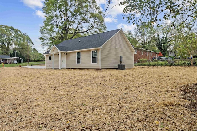 back of house featuring central air condition unit and fence