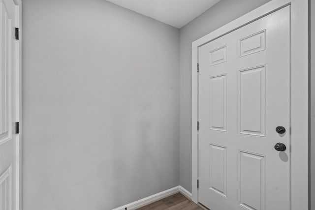 doorway to outside with light wood finished floors and baseboards