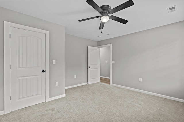 unfurnished bedroom with baseboards, ceiling fan, carpet flooring, and visible vents