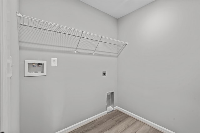 laundry room featuring wood finished floors, laundry area, hookup for an electric dryer, hookup for a washing machine, and baseboards
