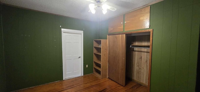 unfurnished bedroom with a textured ceiling and wood finished floors