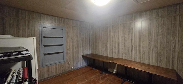 mudroom with wooden walls and dark wood-style floors