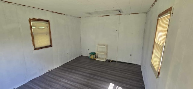 unfurnished room with plenty of natural light and wood finished floors