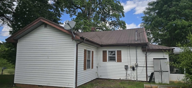 rear view of property featuring metal roof