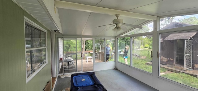 sunroom featuring a ceiling fan and beam ceiling