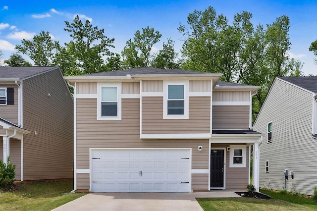view of front of property with board and batten siding, an attached garage, and driveway
