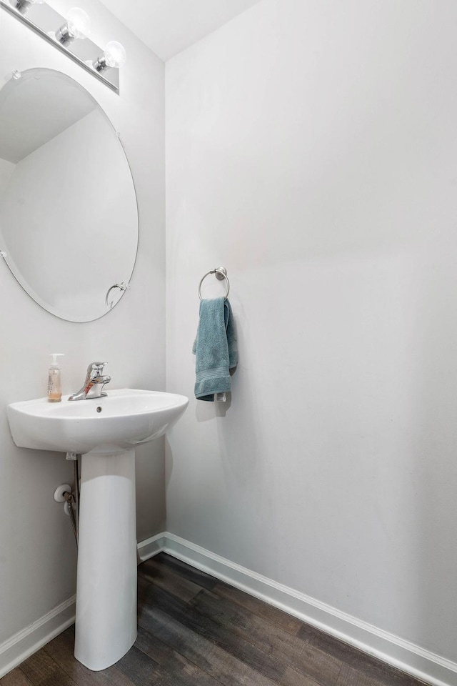 bathroom with baseboards and wood finished floors
