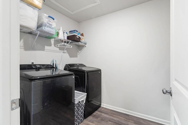 laundry room featuring laundry area, washer and clothes dryer, wood finished floors, and baseboards